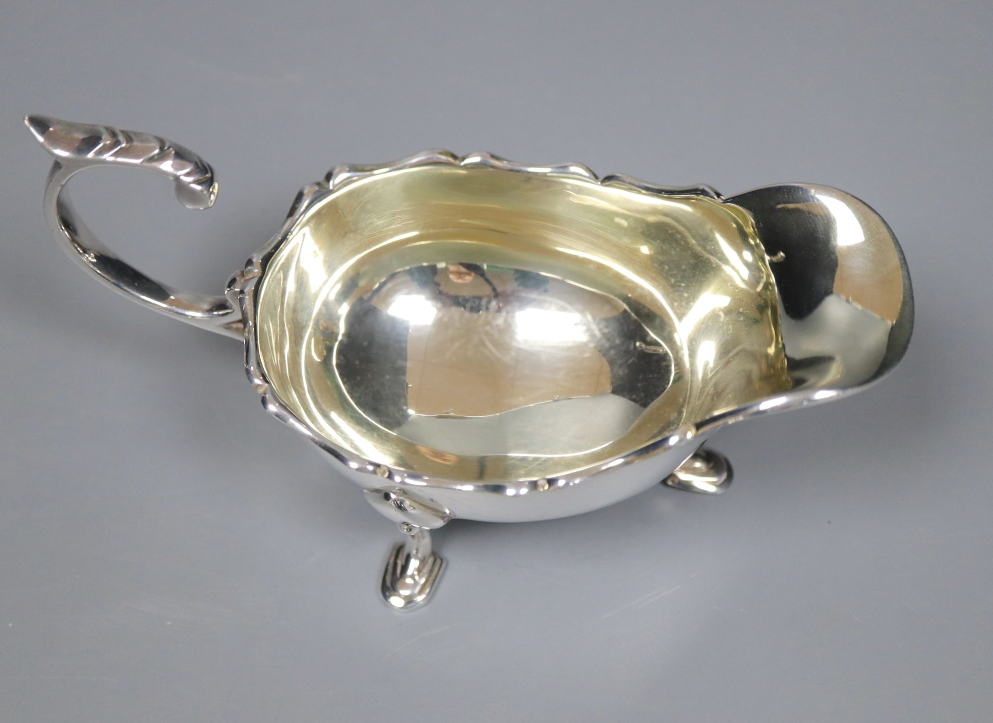 A pair of 1930s silver sauceboats, 5.5 oz and a plated sauceboat.
